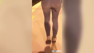 girl pees while walking down the street