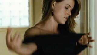 Alice Eve putting on her shirt