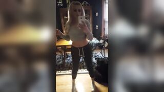 Lexi Belle in front of the mirror.