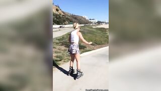 Chick rollerblading onto the beach